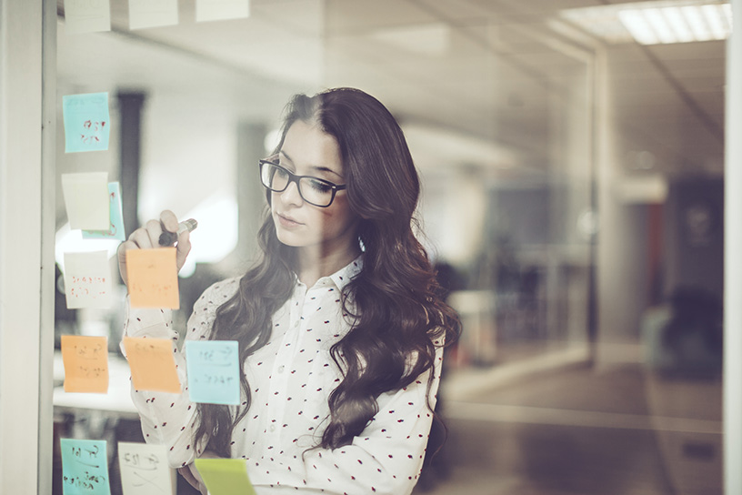 A woman working with kanban cards