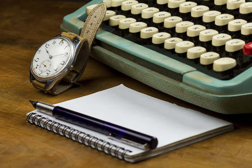 Watch, notepad, and typewriter