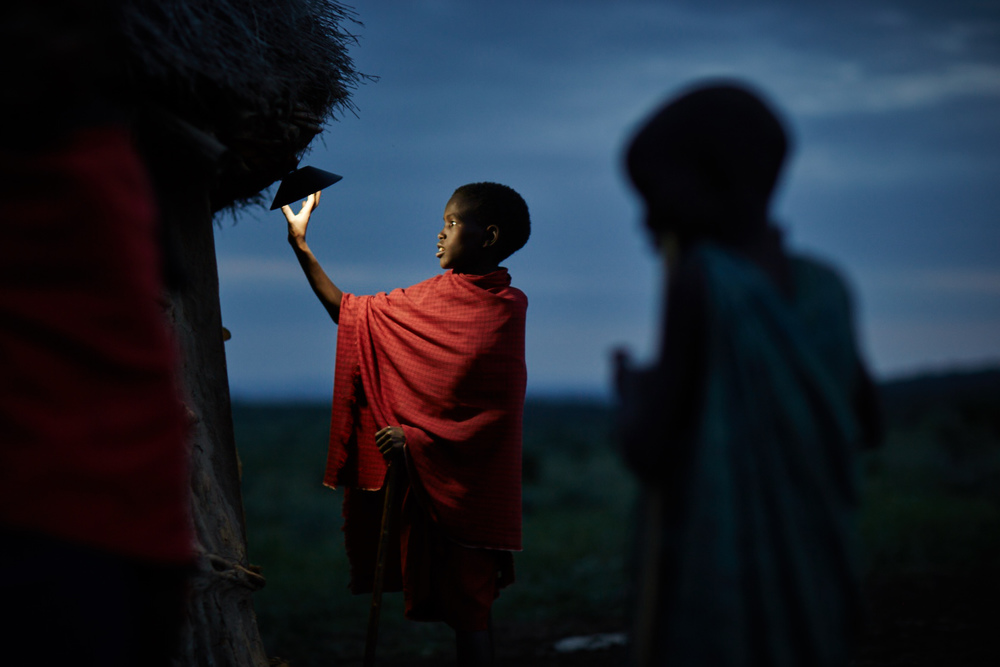 A boy touches a light bulb